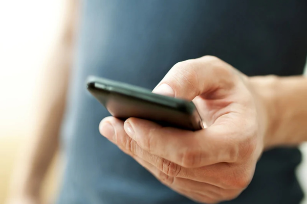 Man watching TV with a remote, enjoying a seamless WiFi connection