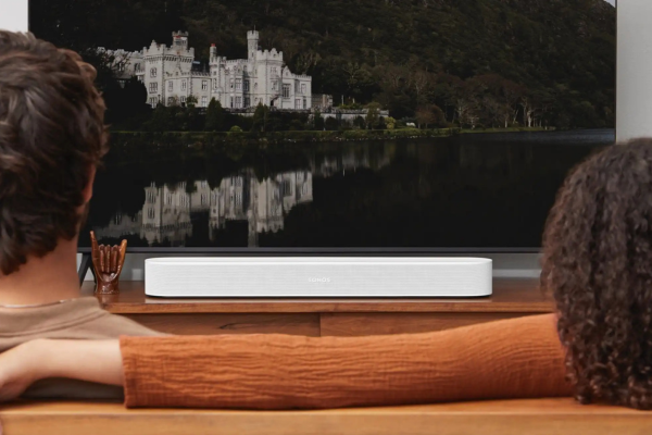 Man watching TV with a remote, enjoying a seamless WiFi connection