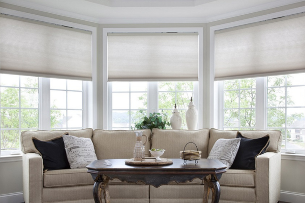 Living room with smart shades installed behind the couch